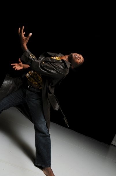 Boris Willis in a wide lunge, head turned, jacket swinging