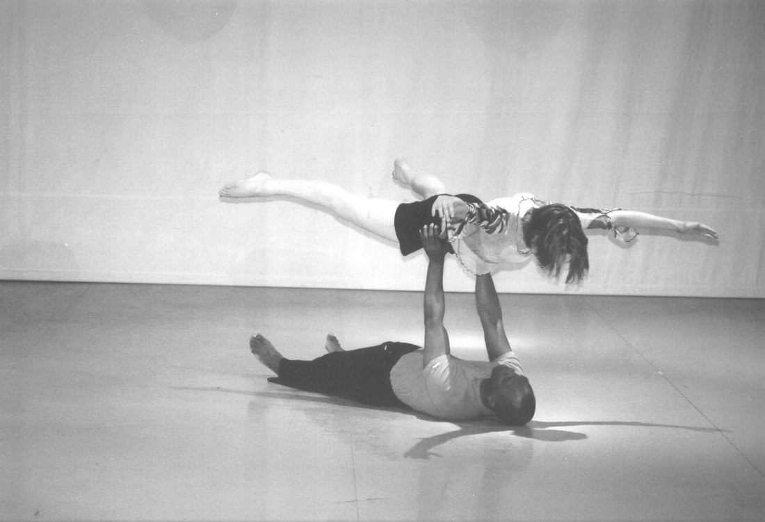 Boris Willis lifting Emily Berry overhead in a horizontal balance in Aliens