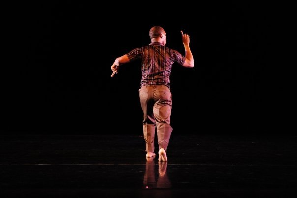 Boris Willis seen from behind with one arm raised
