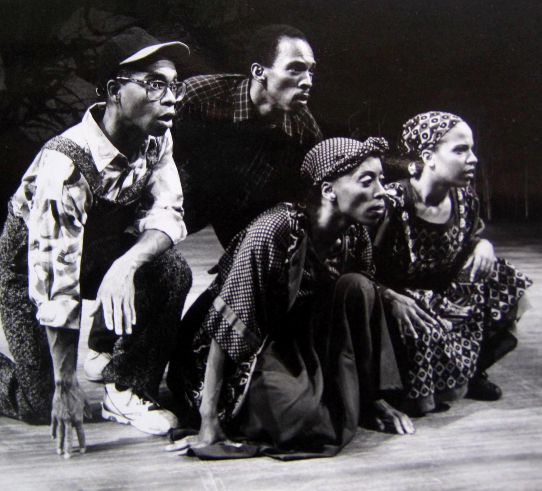 The ensemble of In Living Colors crouched together on stage