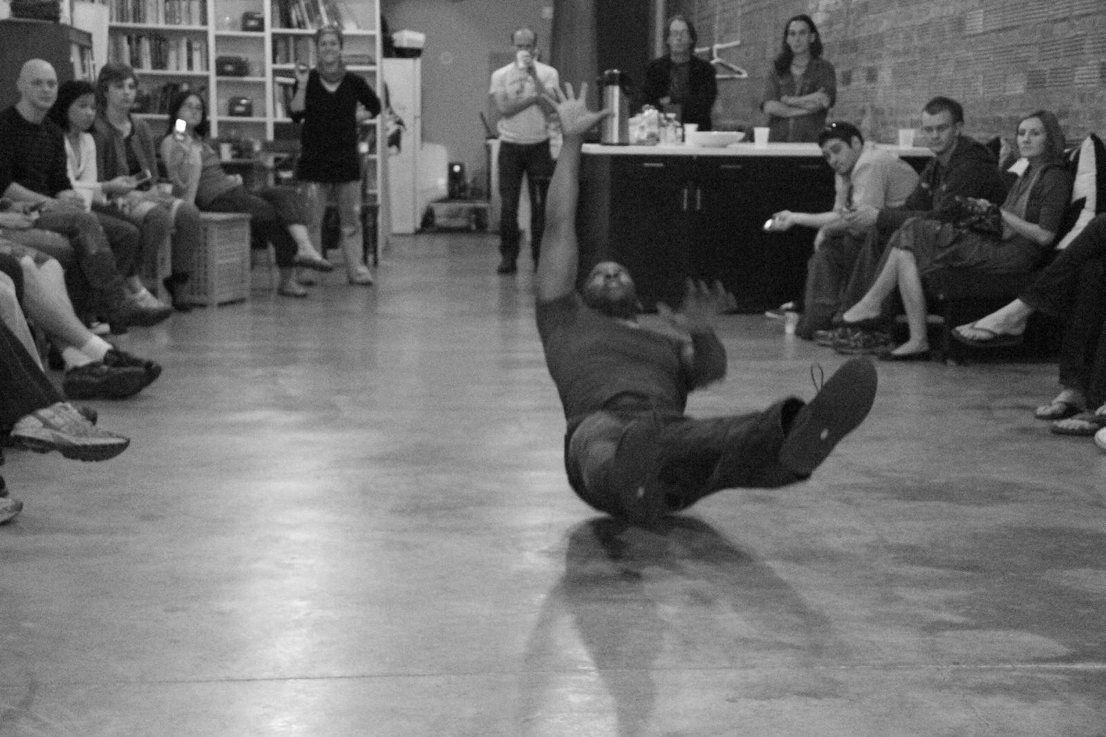 Boris Willis low on the floor, on his back with one leg extended